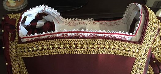 Partially embroidered chemise pinned into neckline for perspective